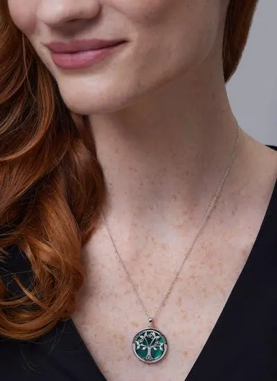 Close up shot of red haired model wearing Sterling Silver Malachite Tree of Life Disc Pendant